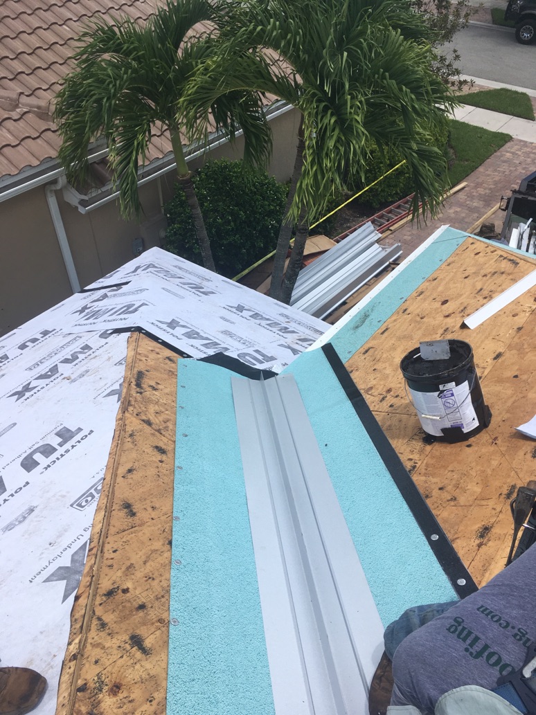 Anchor Construction Group crew installing new valley flashing and underlayment during a roof repair
